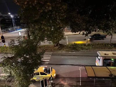 a yellow taxi cab driving down a street at night at Casa Minca in Medellín