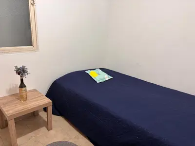 a bedroom with a blue bed and a table at Casa Minca in Medellín