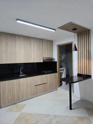 a kitchen with black counters and a black table at Laureles70 in Medellín