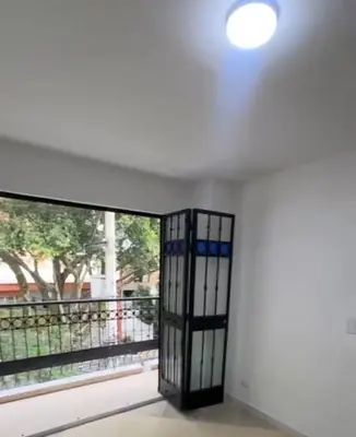 a door in a room with a balcony at Laureles70 in Medellín
