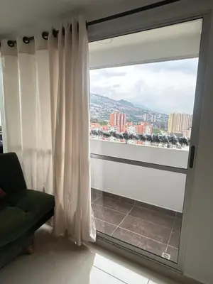 a window with a view of a city at Elena house in Medellín