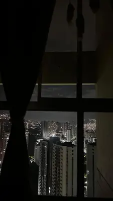 a view of a city at night from a window at Elena house in Medellín