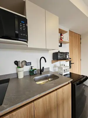 a kitchen with a sink and a microwave at Inner Bloom in Medellín