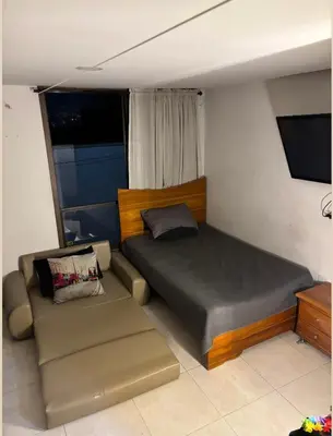 a bed and a couch in a small room at Aparta estudio hasta para 4 personas Max in Medellín