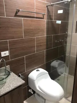 a bathroom with a toilet and a glass shower at Aparta estudio hasta para 4 personas Max in Medellín