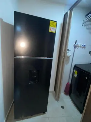 a black refrigerator with a light on top of it at Aparta estudio hasta para 4 personas Max in Medellín