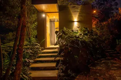 a set of stairs leading to a house at night at Selvva suites cabaña de lujo romántica con jacuzzi in Rionegro