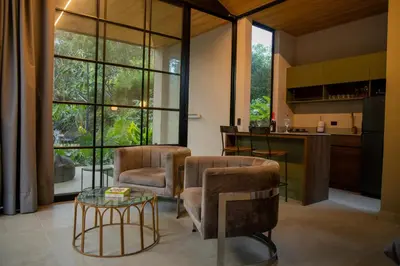 a living room with two chairs and a table at Selvva suites cabaña de lujo romántica con jacuzzi in Rionegro