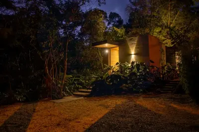 a small house at night with a light on it at Selvva suites cabaña de lujo romántica con jacuzzi in Rionegro