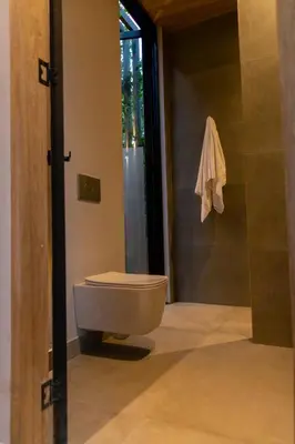 a bathroom with a toilet and a glass door at Selvva suites cabaña de lujo romántica con jacuzzi in Rionegro