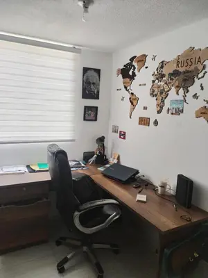an office with a desk with a chair and a map on the wall at Apt en sabaneta in Sabaneta