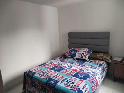 a bedroom with a bed with a colorful bedspread at Apt en sabaneta in Sabaneta