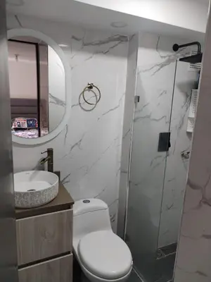 a bathroom with a toilet and a sink and a mirror at Apt en sabaneta in Sabaneta