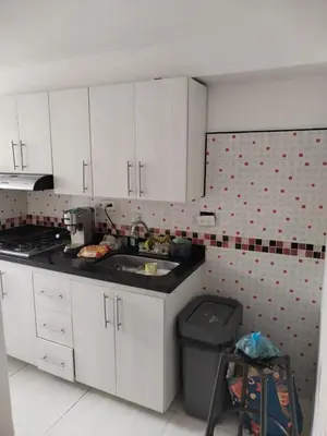 a kitchen with white cabinets and a sink at Apt en sabaneta in Sabaneta