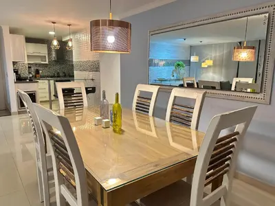 a dining room with a wooden table and chairs at Apartamento familiar en el Poblado Medellín in Medellín