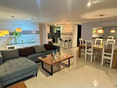 a living room with a couch and a table at Apartamento familiar en el Poblado Medellín in Medellín