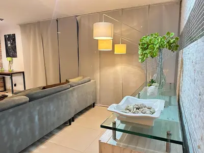 a living room with a couch and a glass table at Apartamento familiar en el Poblado Medellín in Medellín