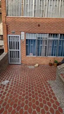 a brick building with doors and a brick floor at Habitación laureles in Medellín
