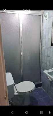 a bathroom with a shower with a toilet and a sink at Habitación laureles in Medellín