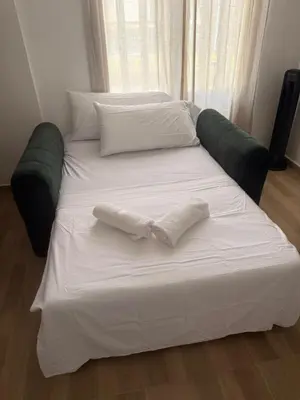 a large white bed with two pillows on it at Apartaestudios Zeni in Medellín