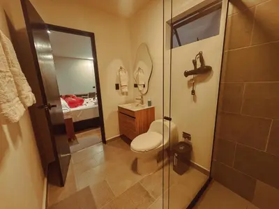 a bathroom with a toilet and a sink and a shower at Apartaestudios Zeni in Medellín
