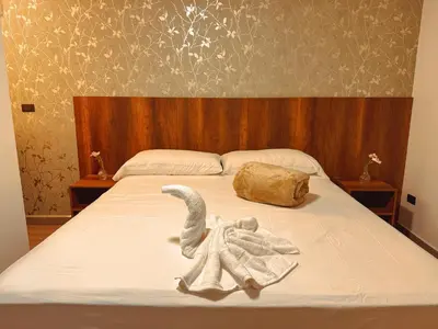 a bed with an elephant made out of towels at Apartaestudios Zeni in Medellín