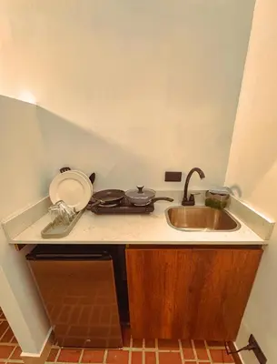 a kitchen with a sink and a counter top at Apartaestudios Zeni in Medellín