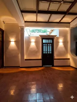 an empty room with a door and lights on the wall at Casa Epoca Dorada in Medellín