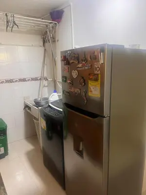 a kitchen with a stainless steel refrigerator with magnets at Apartamento Buenos Aires in Medellín