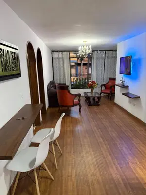 a living room with a table and chairs and a couch at Apartamento céntrico y acogedor in Medellín