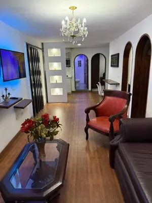 a living room with a couch and a chair at Apartamento céntrico y acogedor in Medellín