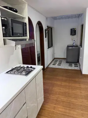 a kitchen with a stove and a counter top at Apartamento céntrico y acogedor in Medellín