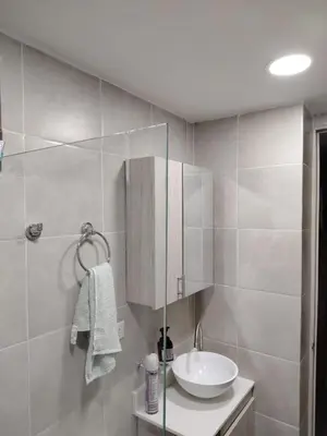 a bathroom with a sink and a mirror at Habitación en Medellín in Medellín