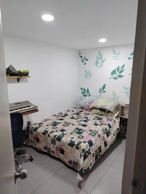 a bedroom with a bed and a desk at Habitación en Medellín in Medellín