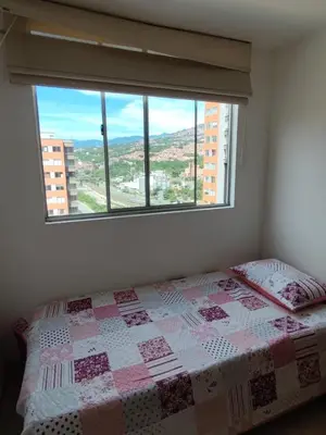 a bedroom with a bed and a large window at Hermosa habitación con múltiples áreas comunes in Bello