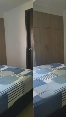 a bedroom with a bed and a wooden cabinet at Habitación en conjunto in Medellín