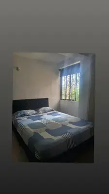 a large bed in a room with a window at Habitación en conjunto in Medellín