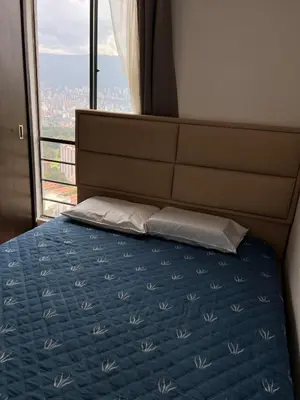 a bedroom with a bed with a large window at Beautiful 29th floor apartment with a view in Medellín