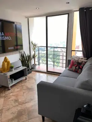 a living room with a couch and a flat screen tv at Beautiful 29th floor apartment with a view in Medellín