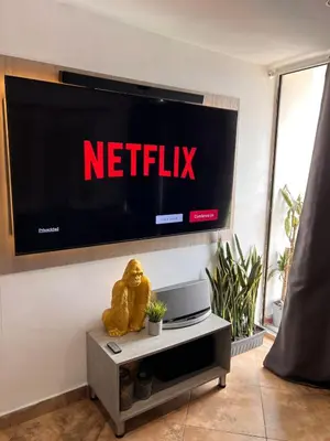 a television with the netflix sign on a wall at Beautiful 29th floor apartment with a view in Medellín