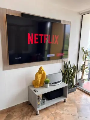 a teddy bear sitting on a table in front of a television at Beautiful 29th floor apartment with a view in Medellín