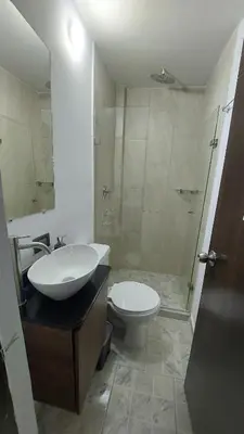 a bathroom with a sink and a toilet and a shower at Laureles Estadio Lofts 33 in Medellín