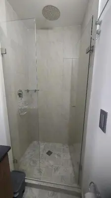 a shower with a glass door in a bathroom at Laureles Estadio Lofts 33 in Medellín