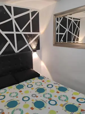 a bedroom with a bed and a window at Apto medellin in Medellín
