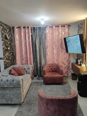 a living room with a couch and a tv at Apto medellin in Medellín