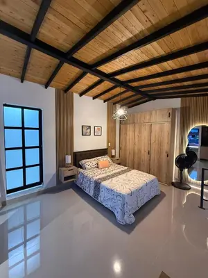 a bedroom with a bed and a wooden ceiling at Apartamento nuevo, moderno y acogedor in Itagüí