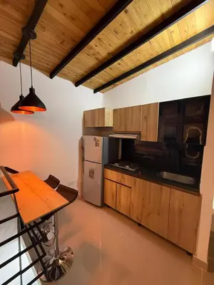 a kitchen with a refrigerator and a table in it at Apartamento nuevo, moderno y acogedor in Itagüí