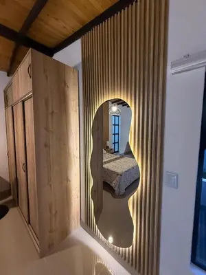 a bedroom with a mirror in a wooden cabinet at Apartamento nuevo, moderno y acogedor in Itagüí
