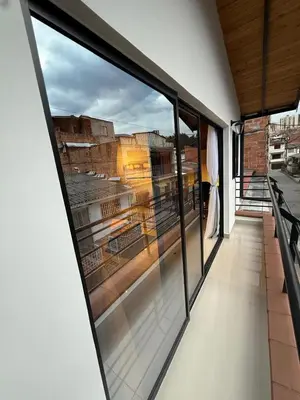 a balcony with a view of a city seen through windows at Apartamento nuevo, moderno y acogedor in Itagüí