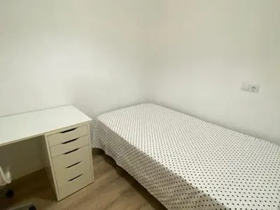 a bedroom with a desk and a bed and a desk and a deskictericter at Apartamento Deluxe poblado in Medellín